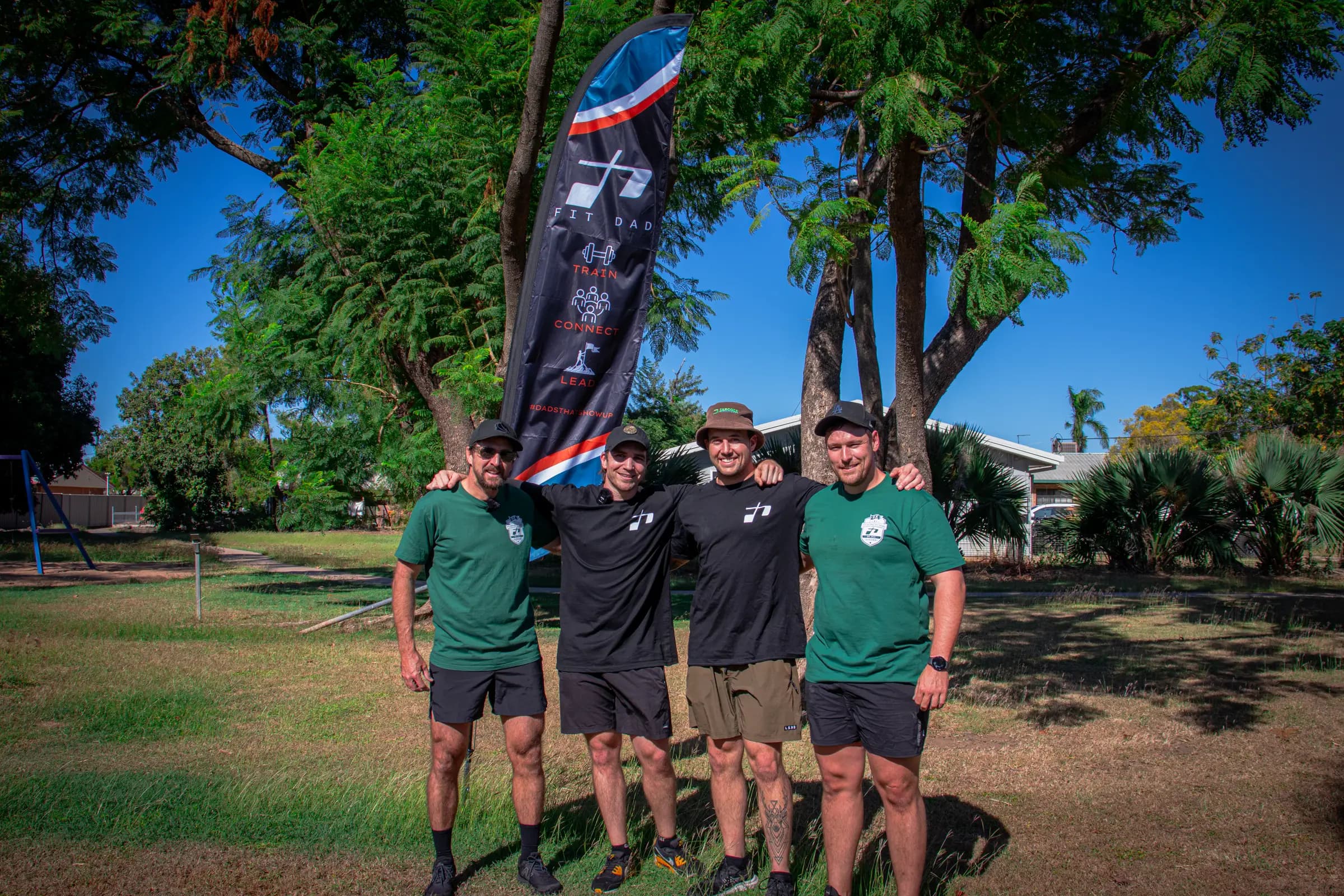 The FitDad Founding Fathers in front of the club banner at Kipling Park